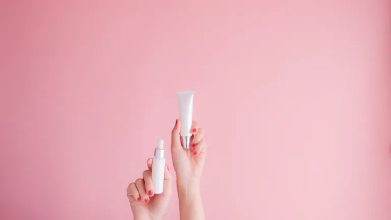 hand hold cosmetic skincare on pink background.beauty banner